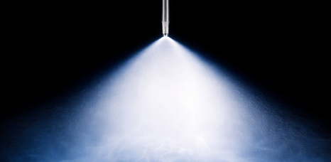 High pressure evaporative cooling nozzle producing fine mist spray for industrial humidification systems